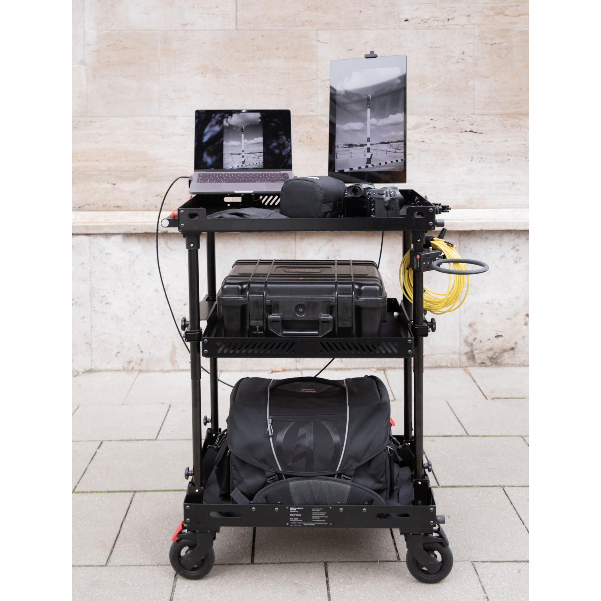 SCHLEPP ONE Camera Cart - lightest Camera Carts in the World. Optional Middle Shelf can be stored inside the cart. 60mm walls (lips) on the top shelf and base shelf protect your gear. Add countless first- and third-party accessories like the Espresso 17" Pro Display for your work on set. Lighter than any Magliner or other production / camera cart, SCHLEPP ONE was designed for single-person use